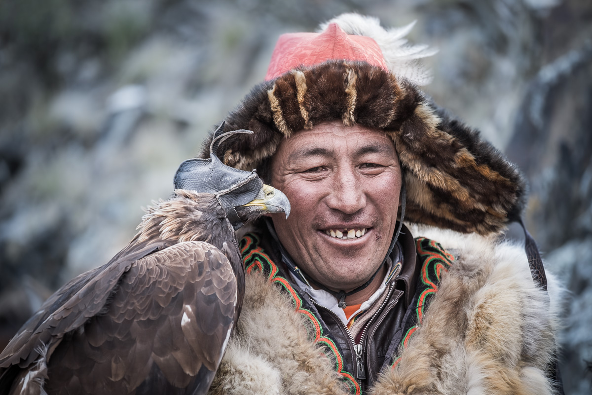 Kazakh eagle hunters are proud and majestic people. It has been a great privilege to photograph them. Eagle is wearing a cap on it's head to keep him calm and free from all distraction. It is removed just before releasing him to fly and catch the prey.